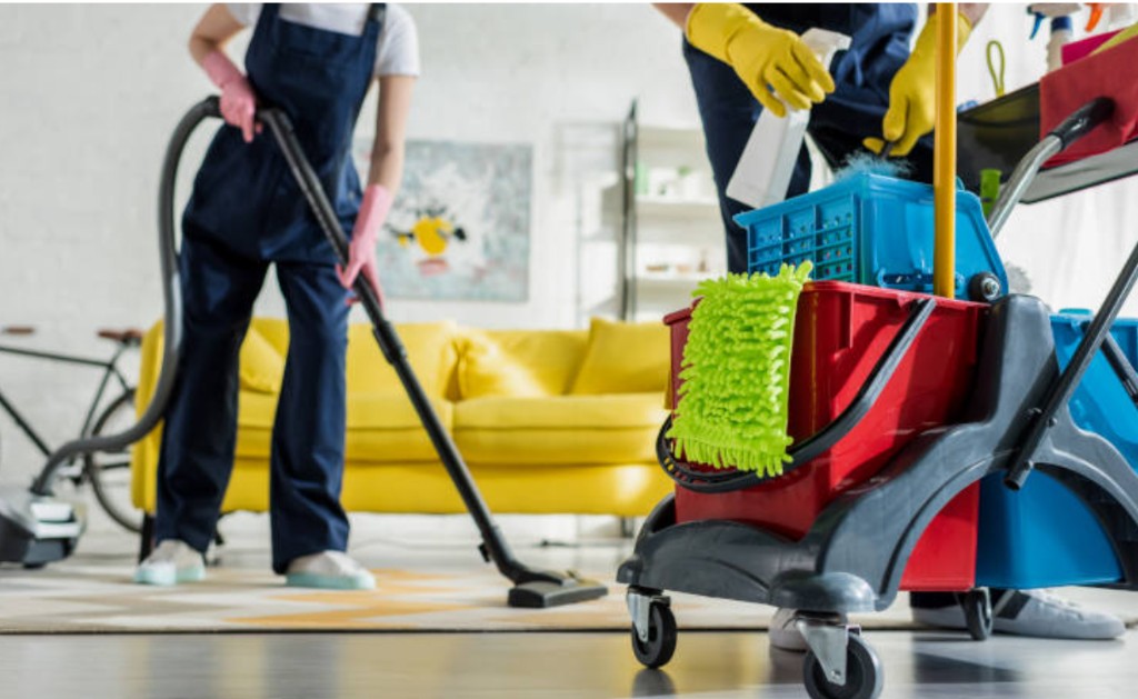 Cleaning team with vacuum and cart